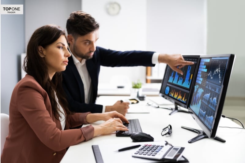 Professional traders analysing charts, representing work environments at the largest prop trading firms.